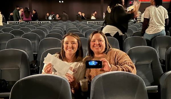 While watching the series finale of "Stranger Things" at the Tara Theatre in Atlanta on New Year's Eve, Kelly DeVoe and her mom, Riley, happened to sit in the same seats where actors Caleb McLaughlin and Sadie Sink kissed during a scene from the show. (Rodney Ho/AJC)