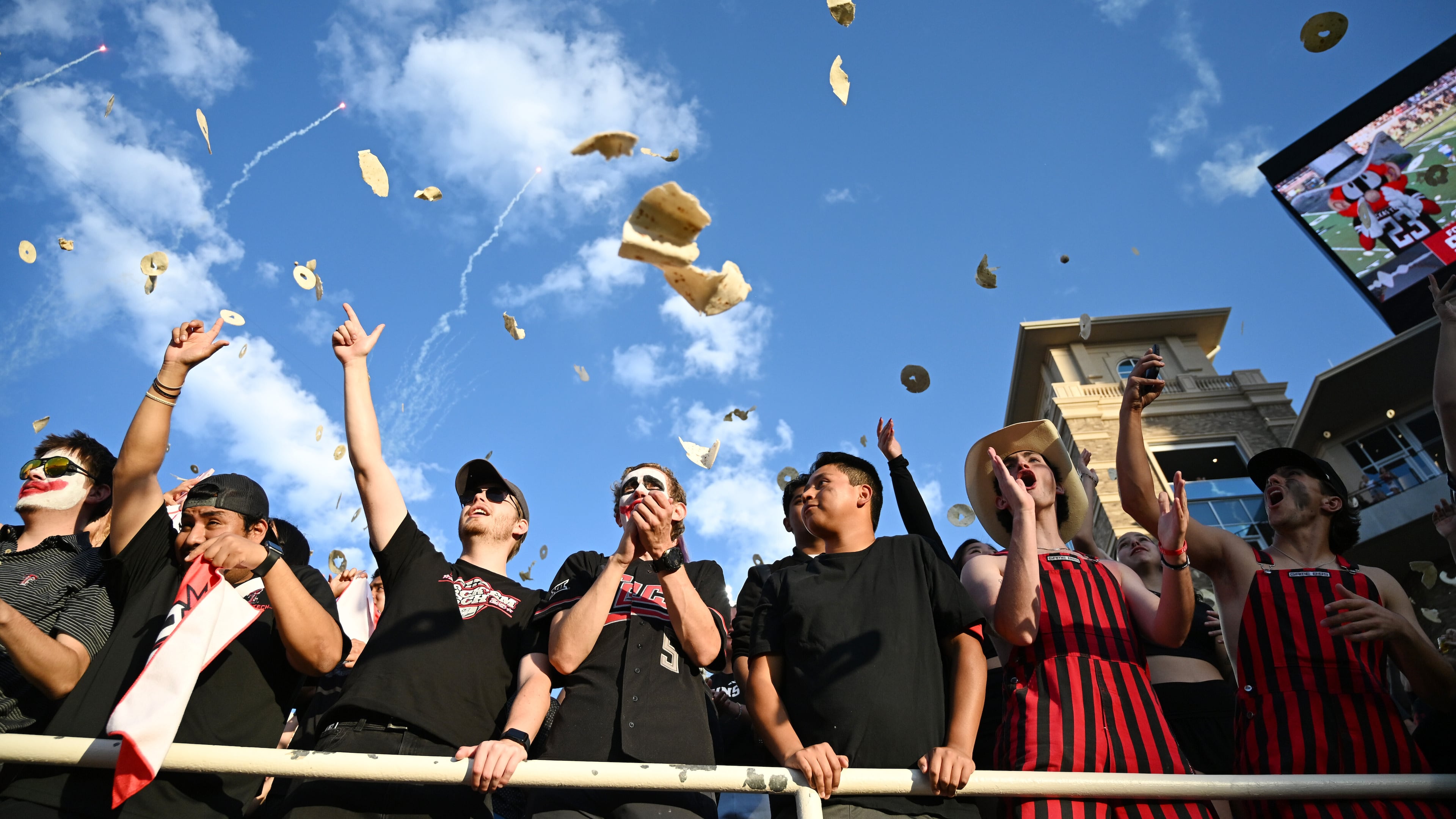 Texas Tech students throw tortillas before the NCAA college football game against Kansas, Saturday, Oct. 11, 2025, in Lubbock, Texas. (AP Photo/Annie Rice)
