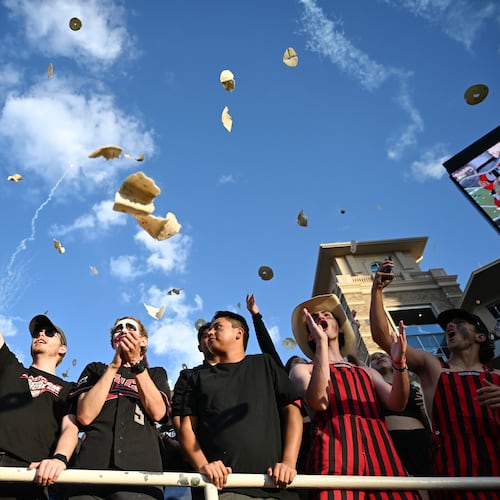 Texas Tech students throw tortillas before the NCAA college football game against Kansas, Saturday, Oct. 11, 2025, in Lubbock, Texas. (AP Photo/Annie Rice)