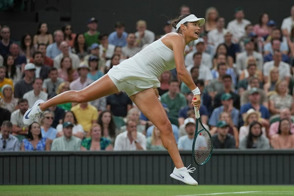 Emma Raducanu of Britain serves to Aryna Sabalenka of Belarus during a third round women's singles match at the Wimbledon Tennis Championships in London, Friday, July 4, 2025. (AP Photo/Kin Cheung)