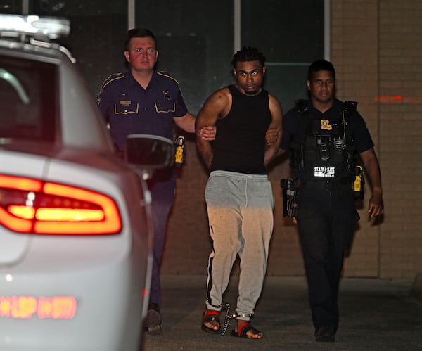 Troopers with Louisiana State Police escort Orleans Parish Prison escapee Lenton Vanburen to a waiting vehicle late Monday, May 26, 2025, at Louisiana State Police Headquarters after he was captured in Baton Rouge, La. (Hilary Scheinuk/The Advocate via AP)
