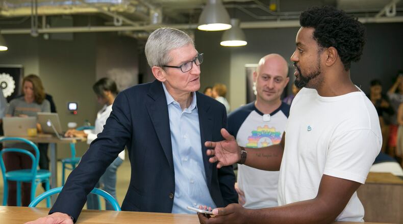 Apple CEO Tim Cook, left, gets a demonstration of the Localeur app from Localeur founder and CEO Joah Spearman at Capital Factory in Austin, Texas, on Friday August 25, 2017. JAY JANNER / AMERICAN-STATESMAN