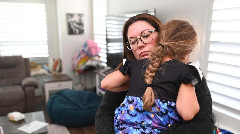 Jennifer Bittner holds her 6-year-old daughter Amelia at their home on Wednesday, Oct. 29, 2025, in Pflugerville, Texas. (AP Photo/Jack Myer)