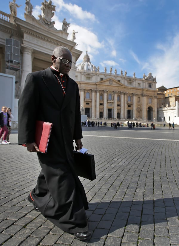 FILE - In this March 4, 2013 file photo, Cardinal Robert Sarah, of Guinea, walks in St. Peter's Square after attending a cardinals' meeting, at the Vatican. (AP Photo/Andrew Medichini, File)