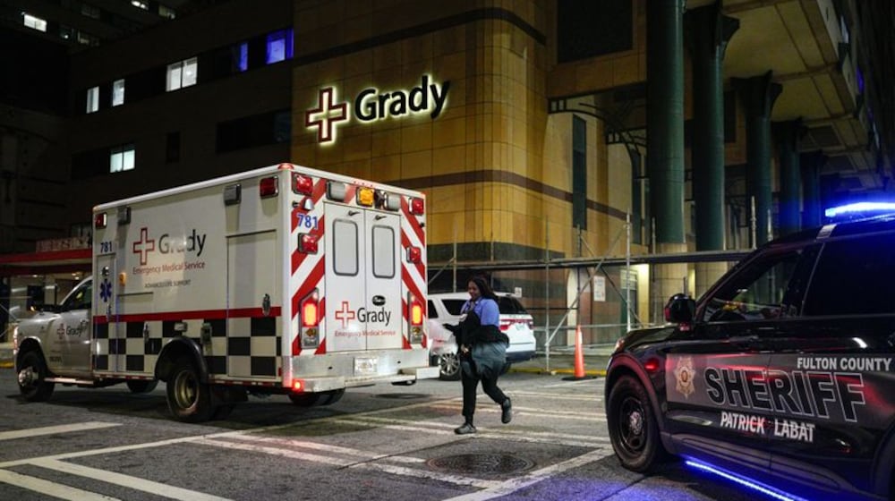 An ambulance arrives at Grady Memorial Hospital late Friday after a fire was reported at the Fulton County Jail. (Ben Hendren for the AJC)