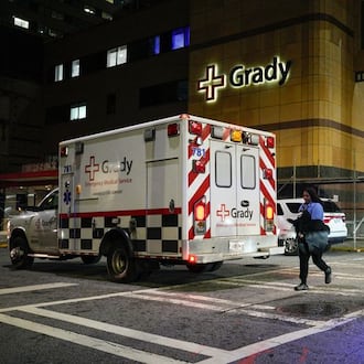 An ambulance arrives at Grady Memorial Hospital late Friday after a fire was reported at the Fulton County Jail. (Ben Hendren for the AJC)