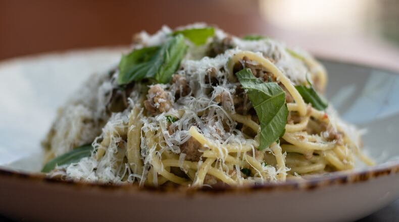 Spaghetti with white Bolognese is topped with torn basil at Donetto in West Midtown. CONTRIBUTED BY HENRI HOLLIS