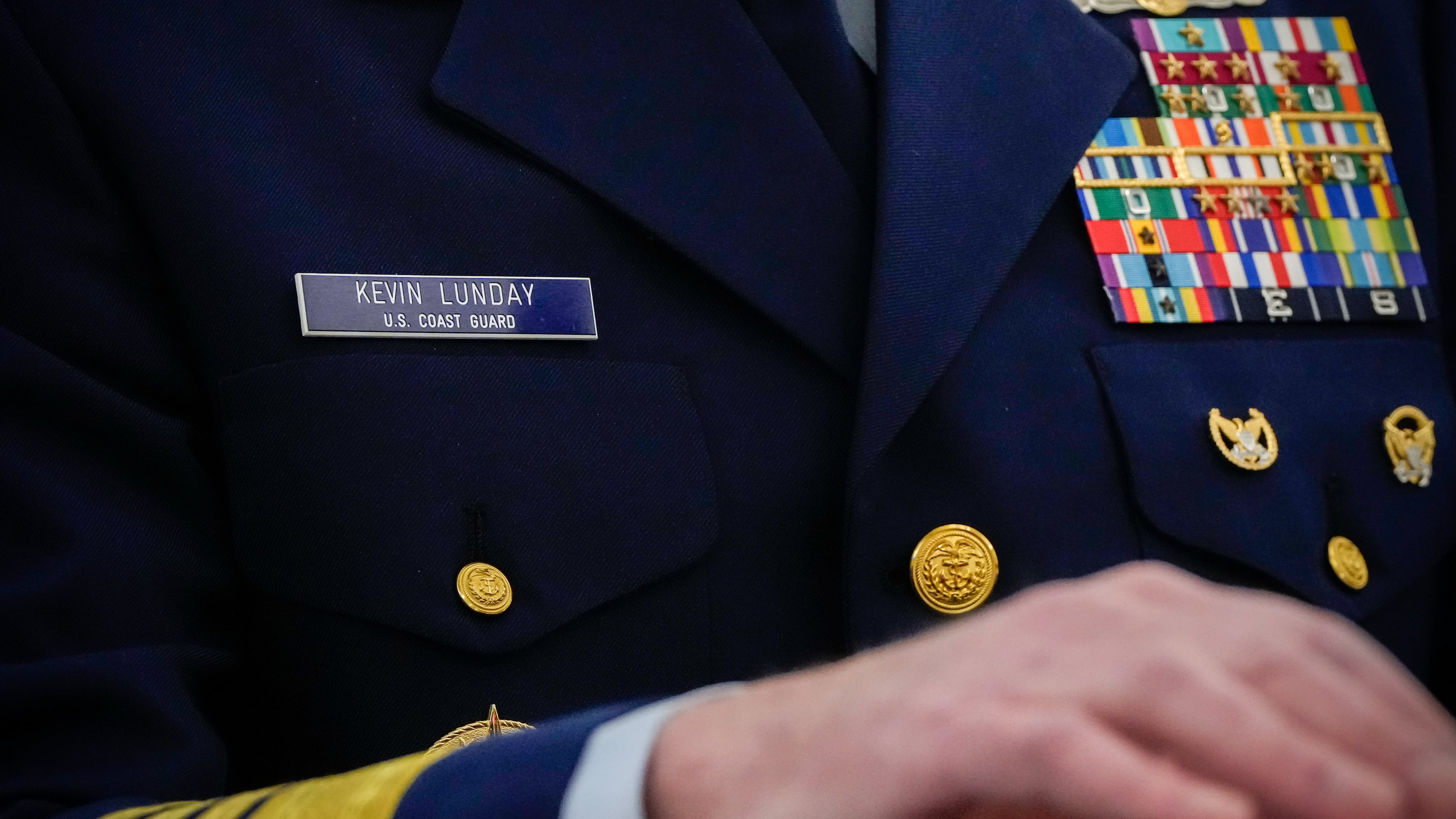 The name tag and ribbons of Adm. Kevin Lunday, acting commandant of the U.S. Coast Guard, are visible as he speaks during a Senate Commerce, Science and Transportation Committee hearing on his nomination for Commandant of the Coast Guard, Wednesday, Nov. 19, 2025, on Capitol Hill in Washington. (AP Photo/Julia Demaree Nikhinson)