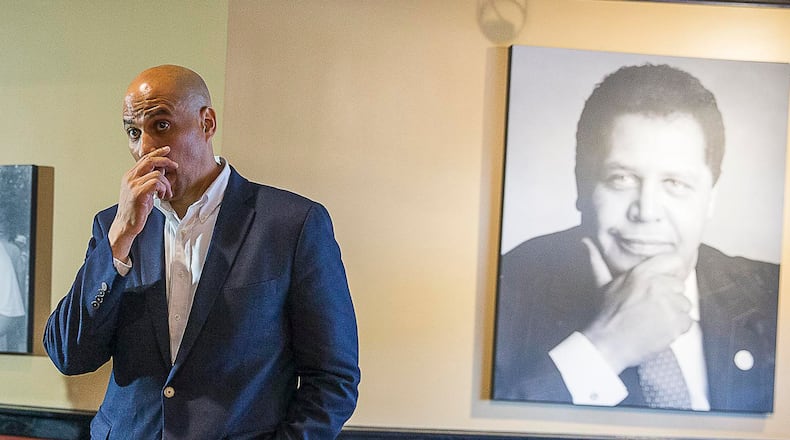 04/17/2019 -- Atlanta, Georgia -- A portrait of Atlanta's first black mayor, Maynard Jackson Jr., is displayed in the banquet room of Paschal's restaurant as U.S. Democrat Presidential hopeful Cory Booker takes a question during a campaign stop at the restaurant in Atlanta's Castleberry Hill community, Wednesday, April 17, 2019. (ALYSSA POINTER/ALYSSA.POINTER@AJC.COM)