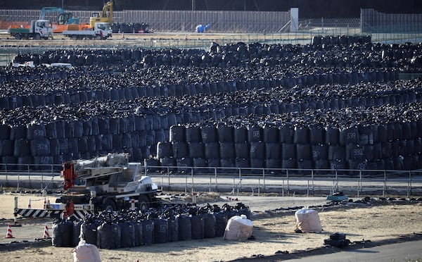 FILE - Black garbage bags filled with radioactivity waste are kept temporally in a field in Minamisoma, Fukushima prefecture, Japan Saturday, March 11, 2017. (Kota Endo/Kyodo News via AP, File)