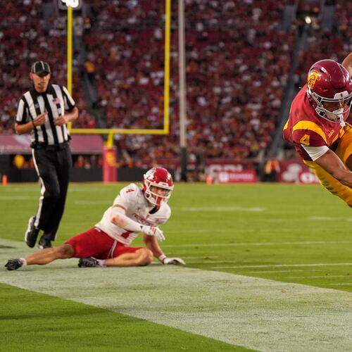 Southern California wide receiver Trent Mosley, right, scores a touchdown as Fresno State defensive back Ethan Tierney watches during the first half of an NCAA college football game, Friday, Sept. 4, 2026, in Los Angeles. (AP Photo/Mark J. Terrill)