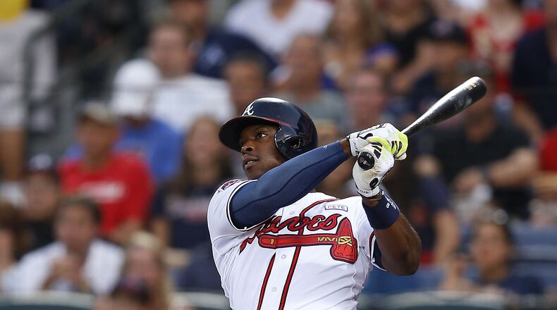 ATLANTA, GA - AUGUST 15: Left fielder Justin Upton #8 of the Atlanta Braves hits a solo home run in the second inning of the game against the Oakland Athletics at Turner Field on August 15, 2014 in Atlanta, Georgia. (Photo by Mike Zarrilli/Getty Images)