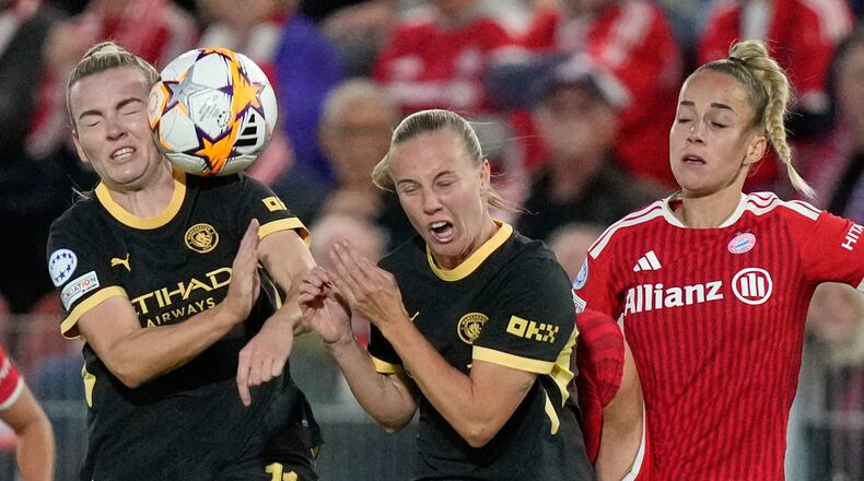 Bayern's Giulia Gwinn, right, collides with Manchester City's Beth Mead and Lauren Hemp, left, during the women's Champions League opening phase soccer match between FC Bayern Munich and Manchester City in Munich, Germany, Tuesday, Sept. 22, 2026. (AP Photo/Matthias Schrader)