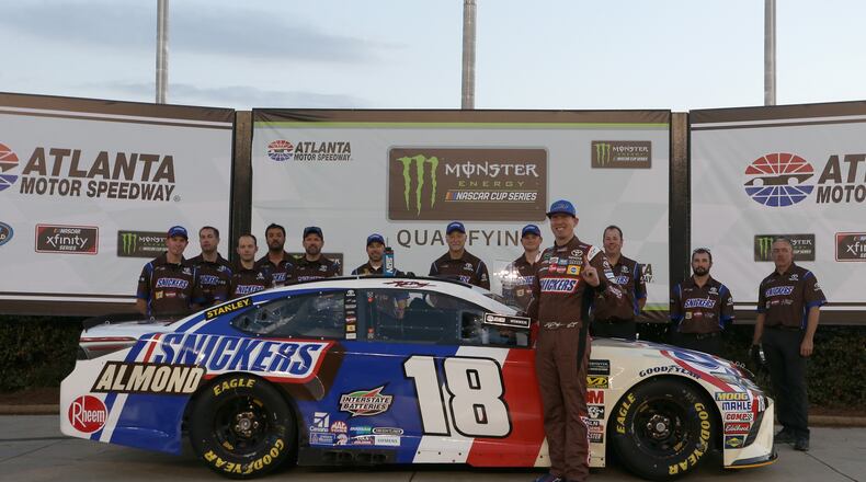 Kyle Busch, driver of the #18 Snickers Almond Toyota, poses with the Pole Award trophy after qualifying for the pole position for the Monster Energy NASCAR Cup Series Folds of Honor QuikTrip 500 at Atlanta Motor Speedway on February 23, 2018 in Hampton, Georgia.  (Photo by Brian Lawdermilk/Getty Images)