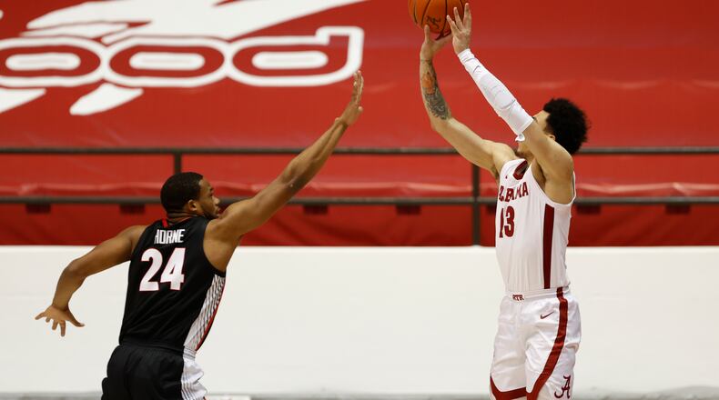 Georgia's P.J. Horne (24), here defending Alabama's Jahvon Quinerly, and the Bulldogs played poor perimeter defense in a 33-point loss to the Crimson Tide this past Saturday in Tuscaloosa. (Photo from UA Athletics) 
Photo by Crimson Tide Photos