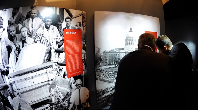 Visitors view archival images from the funeral for Martin Luther King, Jr., at the National Center for Civil and Human Rights Tuesday, June 10, 2014, in Atlanta. The NCCHR tells a story broader than the American civil rights movement, linking that movement to the international current of human rights reform that took inspiration in Atlanta. David Tulis / AJC Special