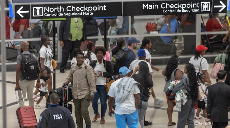 Airport customer service workers move travelers through the North side of the domestic terminal on Friday, Aug. 30, 2024 as the last hurrah of the summer saw yet another packed weekend at Hartsfield-Jackson International Airport. The peak day was expected to be Friday, when more than 349,000 people were expected to travel to, from or through the Atlanta airport. (John Spink/AJC)