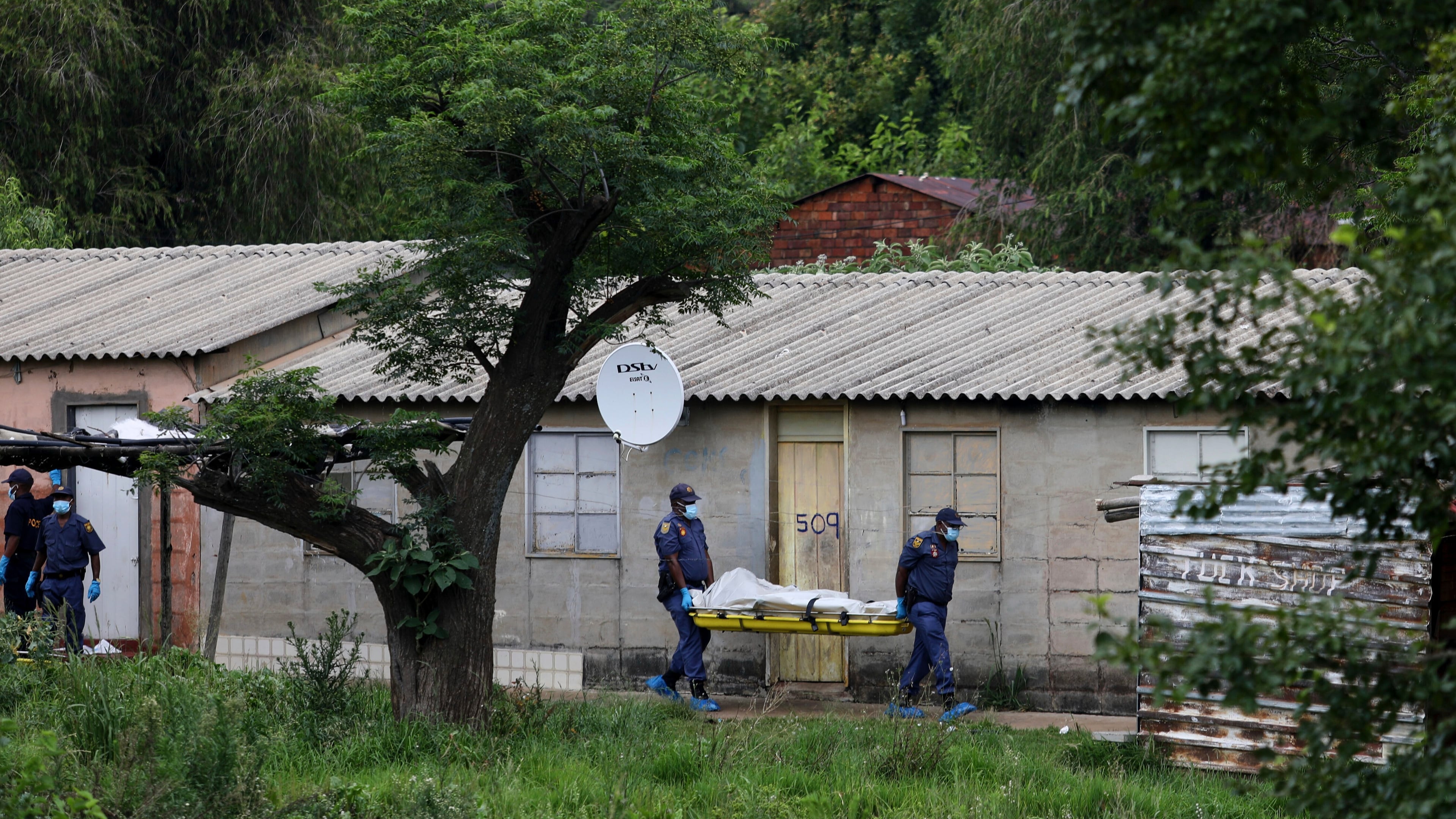 Police officers carry the body of a person on a stretcher after a mass shooting at a bar near Pretoria, South Africa, Saturday, Dec. 6, 2025. (AP Photo)