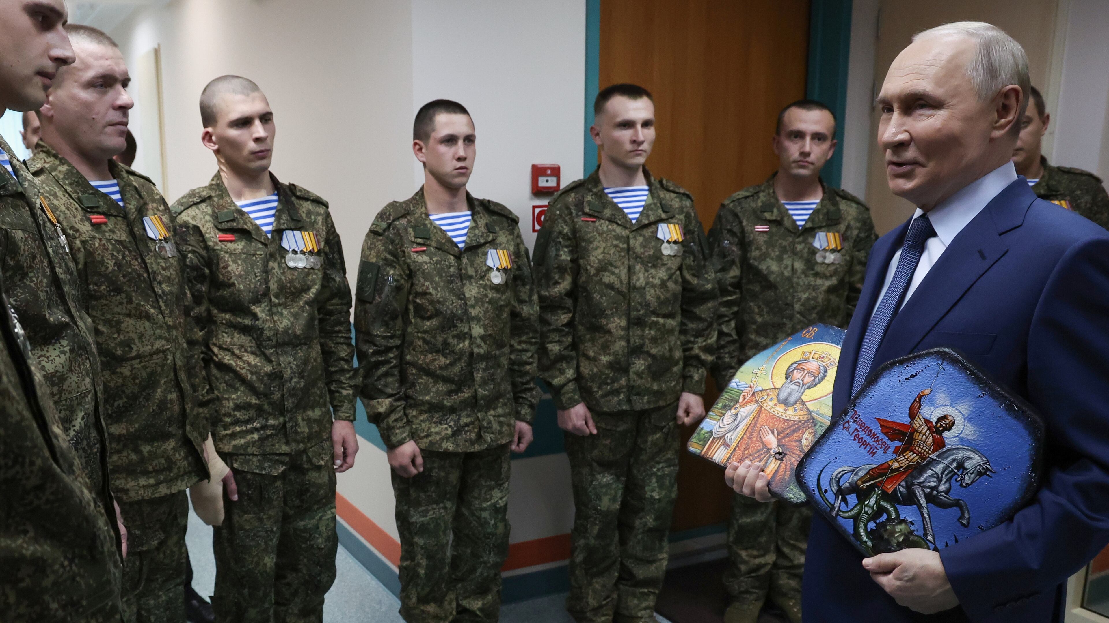 President Vladimir Putin holds Russian Orthodox icons as he meets with soldiers wounded in action in Ukraine, at the the Mandryk Central Military Clinical Hospital, in Moscow, Russia, Wednesday, Oct. 29, 2025. (Vyacheslav Prokofyev, Sputnik, Kremlin Pool Photo via AP)
