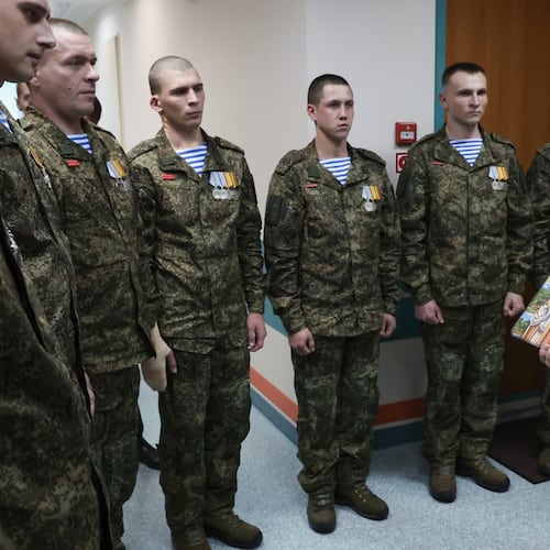 President Vladimir Putin holds Russian Orthodox icons as he meets with soldiers wounded in action in Ukraine, at the the Mandryk Central Military Clinical Hospital, in Moscow, Russia, Wednesday, Oct. 29, 2025. (Vyacheslav Prokofyev, Sputnik, Kremlin Pool Photo via AP)