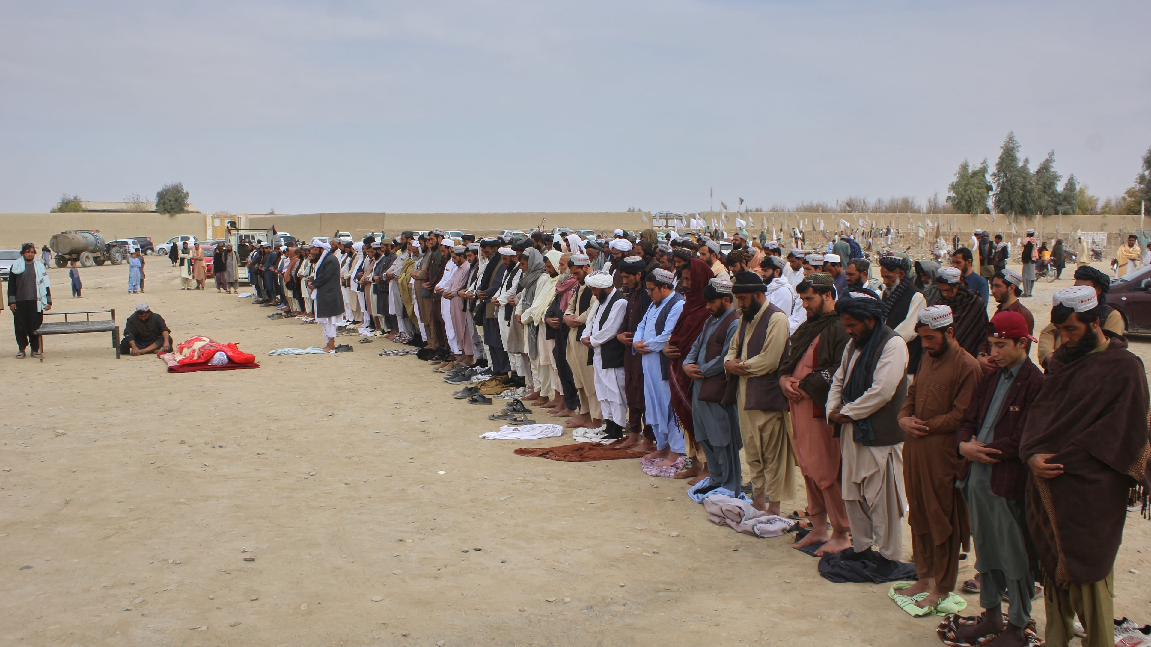Afghans pray during the funeral of a man killed during an overnight exchange of fire between Afghan and Pakistani forces along the border in Spin Boldak, Kandahar province, Afghanistan, Saturday, Dec. 6, 2025. (AP Photo/Sibghatullah)