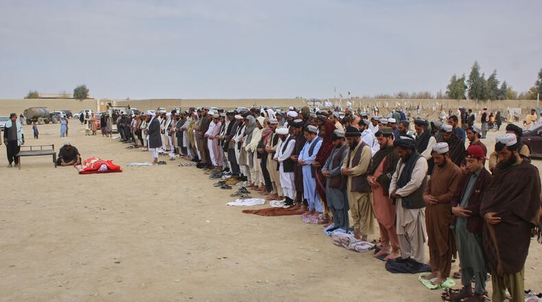 Afghans pray during the funeral of a man killed during an overnight exchange of fire between Afghan and Pakistani forces along the border in Spin Boldak, Kandahar province, Afghanistan, Saturday, Dec. 6, 2025. (AP Photo/Sibghatullah)