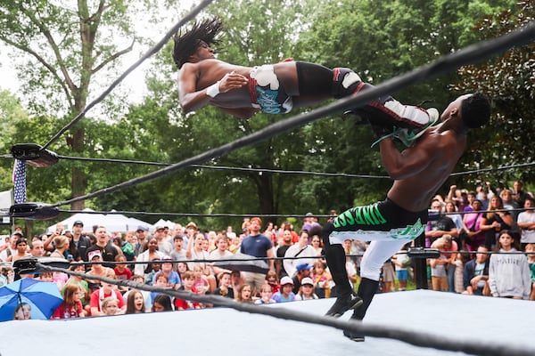 Deep South Wrestling’s DJ Smoke kicks Jay Alpha Miller in the air during the show at the Summer Shade Festival at Grant Park in Atlanta on Saturday, August 23, 2025. (Abbey Cutrer/AJC)