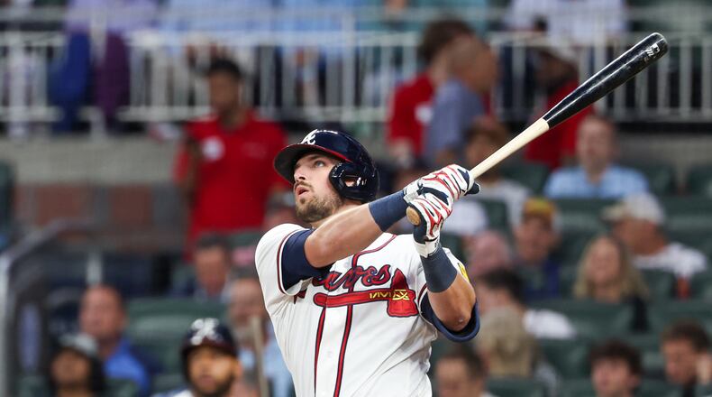 Braves third baseman Austin Riley hits a home run in the fifth inning against the Cubs at Truist Park on May 12, 2026. Correcting a dipping front left shoulder when he bats could improve his performance. (Arvin Temkar/AJC)