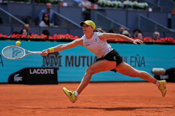 Iga Swiatek of Poland returns the ball against Russia's Diana Shnaider during the Madrid Open tennis tournament in Madrid, Spain, Tuesday, April 29, 2025. (AP Photo/Manu Fernandez)