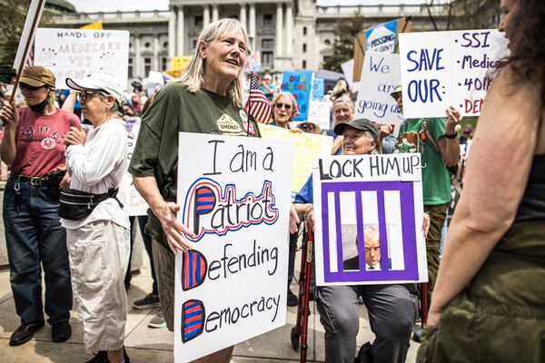 Protesters rally at the state capitol in Harrisburg, Pa., during the Day of Action protest against the Trump Administration. Saturday, April 19, 2025. (Zach Gleiter/The Patriot-News via AP)