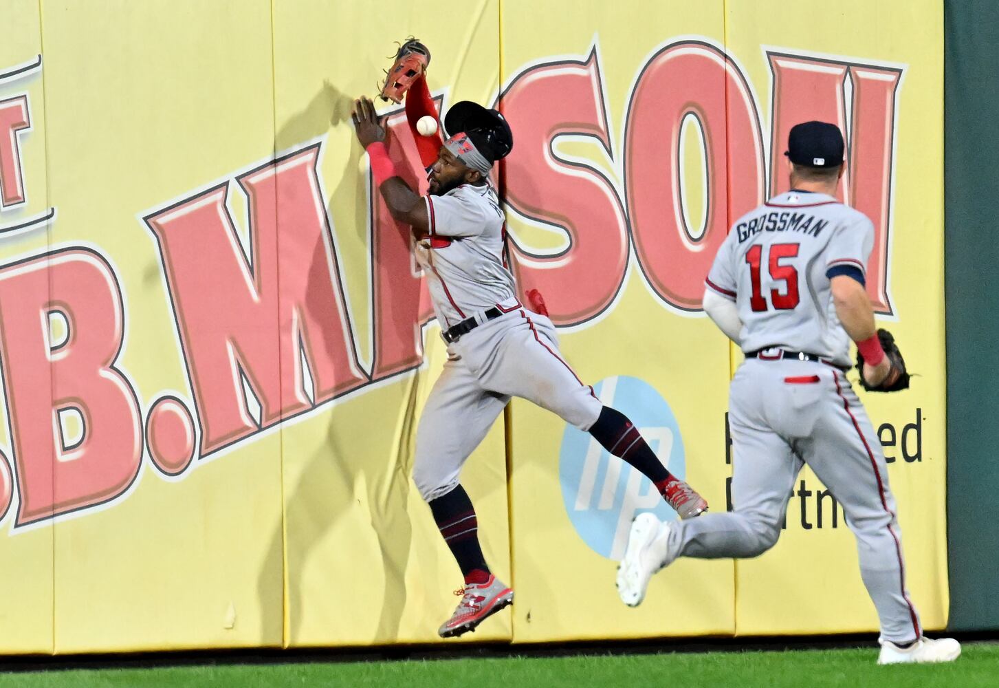 Atlanta Braves center fielder Michael Harris (23) bobbles a fly ball at the outfield wall hit by Philadelphia Phillies’ Bryce Harper (3) for an RBI double as Robbie Grossman (15) backs him up during the seventh inning of game three of the National League Division Series at Citizens Bank Park in Philadelphia on Friday, October 14, 2022. (Hyosub Shin / Hyosub.Shin@ajc.com)