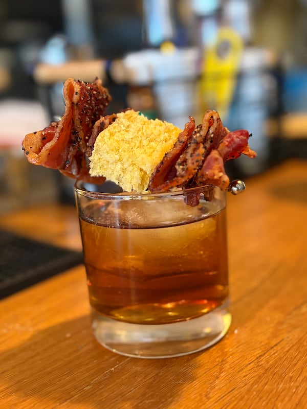 The Samuelsson Smoke Show, finished with a pepper, maple bacon and torch cornbread skewer, will be available on the regular cocktail menu beginning April 4 at Marcus Bar and Grille. (Courtesy of Marcus Bar and Grille)