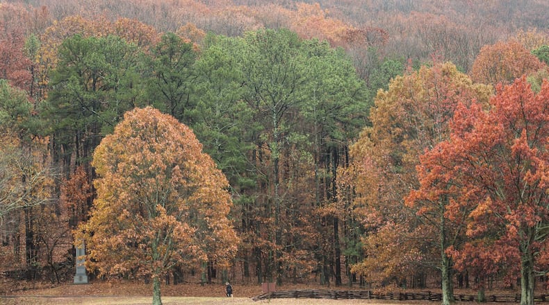 Two people walk at the base of Kennesaw Mountain on an overcast day, Tuesday, Dec. 6, 2016, in Kennesaw, Ga. Branden Camp/Special