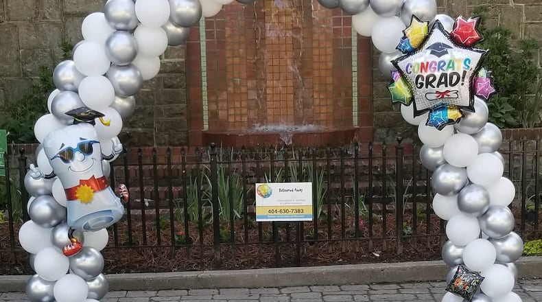 Grant Park resident Maureen Dougher decided to turn a negative into a positive by posting a pop-up balloon display in Grant Park near the Milledge Fountain for graduates to use as a picture backdrop.
