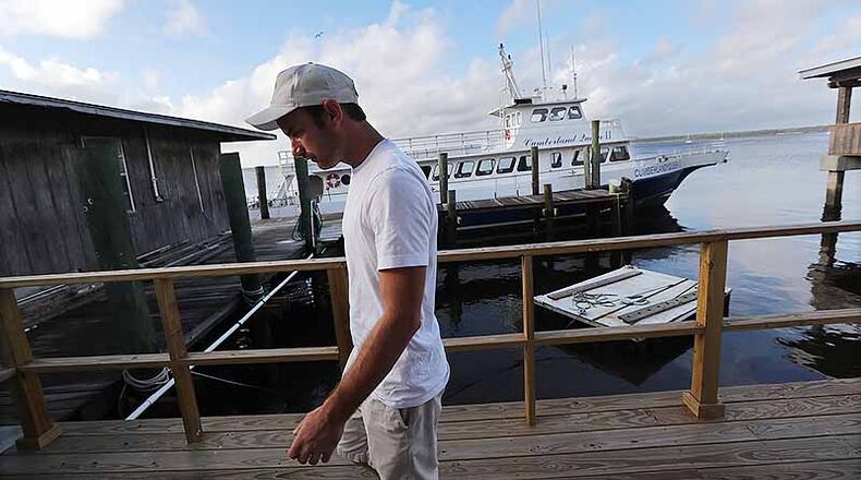 Captain Jeffery Williams walks Tuesday to the Cumberland Queen II at the dock in St. Marys, Georgia’s southernmost coastal city, while waiting out Hurricane Dorian. Curtis Compton/ccompton@ajc.com