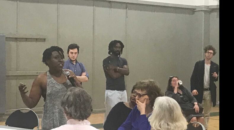 University of Georgia graduate student Rachelle Berry, holding the microphone, discussed ways they can pressure university administrators to address some of their issues with the school. ERIC STIRGUS / ESTIRGUS@AJC.COM.