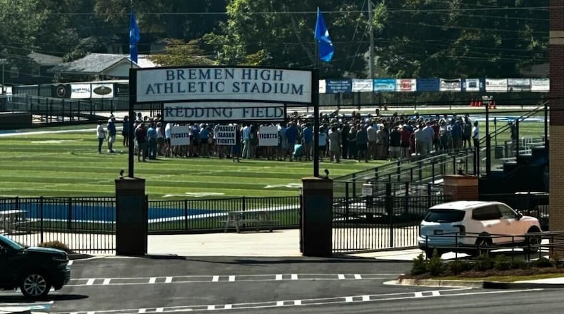 Community members gather on the football field at Bremen High School to pray for Carson Kimball.