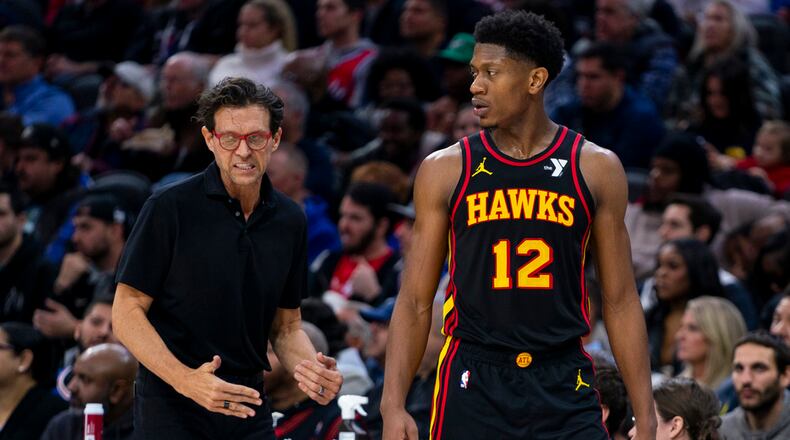 Atlanta Hawks coach Quin Snyder, left, reacts while talking with De'Andre Hunter during the second half of the team's NBA basketball game against the Philadelphia 76ers, Friday, Dec. 8, 2023, in Philadelphia. (AP Photo/Chris Szagola)