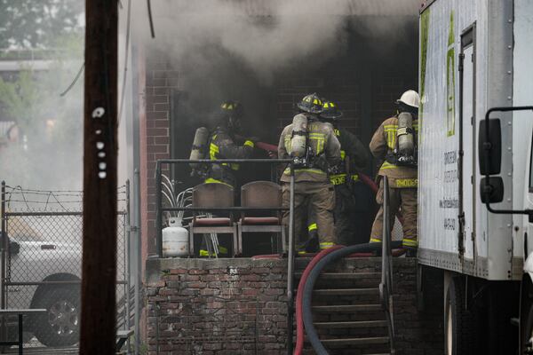 Atlanta fire crews battle a fire at the Furniture Bank of Metro Atlanta, a nonprofit that provides furniture to those in need, on Wednesday, June 18, 2025. (Ben Hendren for the AJC)