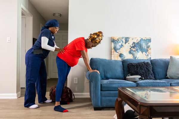 Doula Bashellia Williams walks her client, Reona Porter, through laboring positions at Porter’s Stockbridge apartment on Friday, Oct. 8, 2024. Porter is just over 38 weeks pregnant. 
(Bita Honarvar for The Atlanta Journal-Constitution)