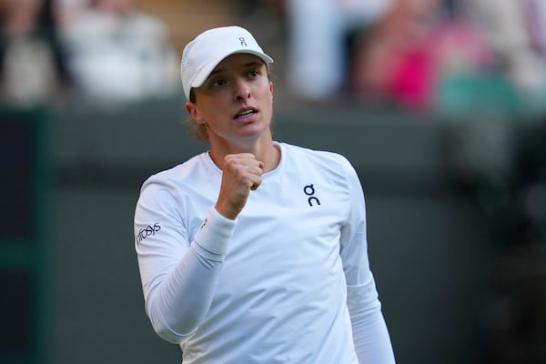 Iga Swiatek of Poland celebrates a point during the women's singles fourth round match against Clara Tauson of Denmark at the Wimbledon Tennis Championships in London, Monday, July 7, 2025.(AP Photo/Kirsty Wigglesworth)