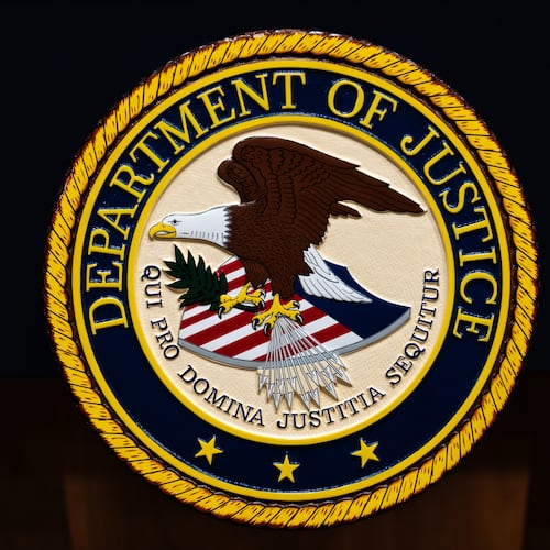 FILE - The U.S. Department of Justice logo is seen on a podium before a news conference, May 4, 2026, in Washington. (AP Photo/Julia Demaree Nikhinson, File)