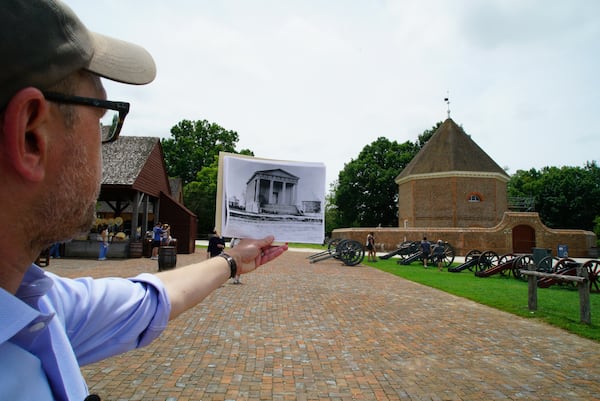 Archaeologist Jack Gary holds up a photo of a church that once stood beside the gunpowder magazine at Colonial Williamsburg in Williamsburg, Va., on Thursday, My 29, 2025. (AP Photo/Allen G. Breed)