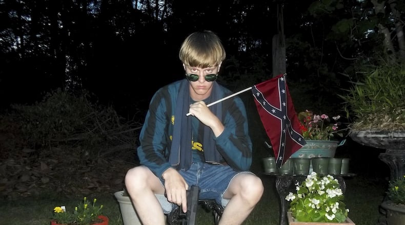 This undated photo that appeared on Lastrhodesian.com, a website investigated by the FBI in connection with Dylann Roof, shows him posing for a photo holding a Confederate flag. Roof, who would later admit he wanted to start a race war, fatally shot eight black worshippers and their pastor at the Emanuel African Methodist Episcopal Church in Charleston, South Carolina. The following week, Obama delivered the eulogy for the slain Rev. Clementa Pinckney, speaking about the symbolism of the Confederate flag and how racial bias infects everyday life. (Lastrhodesian.com via AP, File)