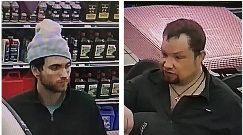 Gwinnett County police are searching for two men suspected of stealing credit cards from cars and using them at a gas station.