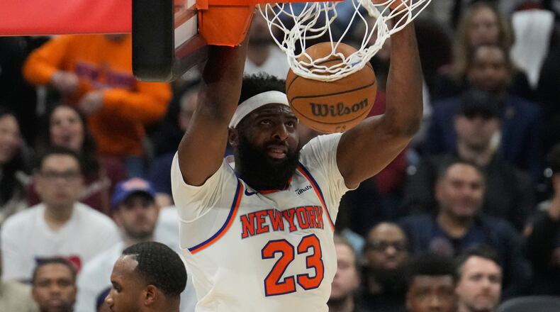 New York Knicks center Mitchell Robinson dunks during the second half of Game 4 in the Eastern Conference finals NBA basketball playoffs series against the Cleveland Cavaliers in Cleveland, Monday, May 25, 2026. (AP Photo/Sue Ogrocki)