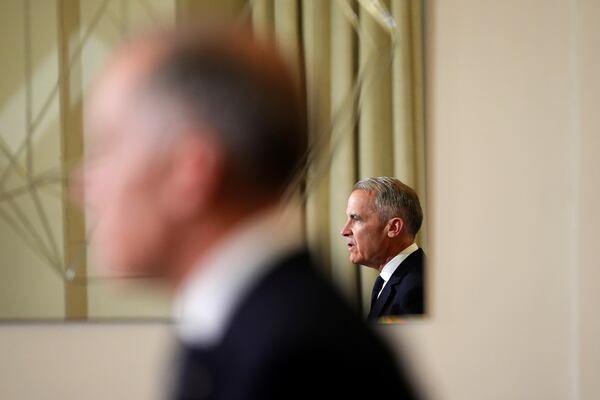 FILE - Canada's Prime Minister Mark Carney, reflected in a mirror, speaks to media during a press conference at Canada House in London on March 17, 2025. (Sean Kilpatrick/The Canadian Press via AP, File)