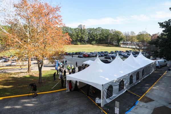 People gather in the parking lot during a groundbreaking of the Civic Center redevelopment outside of the Civic Center in Atlanta on Tuesday, Dec. 9, 2025. Atlanta Housing broke ground on the Historic Civic Center Redevelopment first phase of construction, launching 148 affordable senior housing units. (Abbey Cutrer/AJC)
