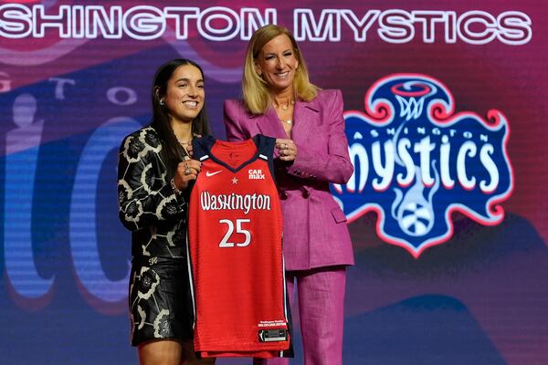 Kentucky's Georgia Amoore, left, poses for a photo with WNBA commissioner Cathy Engelbert after being selected sixth overall by the Washington Mystics during the first round of the WNBA basketball draft, Monday, April 14, 2025, in New York. (AP Photo/Pamela Smith)