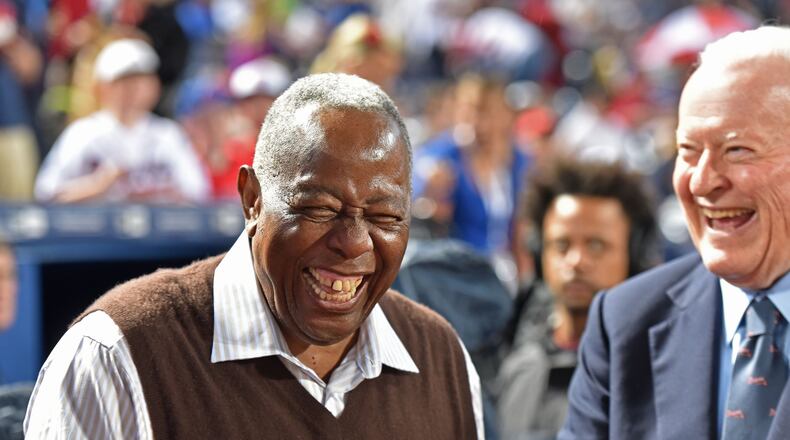 Former Braves owner Bill Bartholomay (right) shares a laugh with Hank Aaron before the Braves’ home opener this year. HYOSUB SHIN / HSHIN@AJC.COM